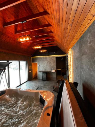a large indoor hot tub in a room with water at LakeHome&Spa nad Jeziorem Czorsztyńskim in Kluszkowce
