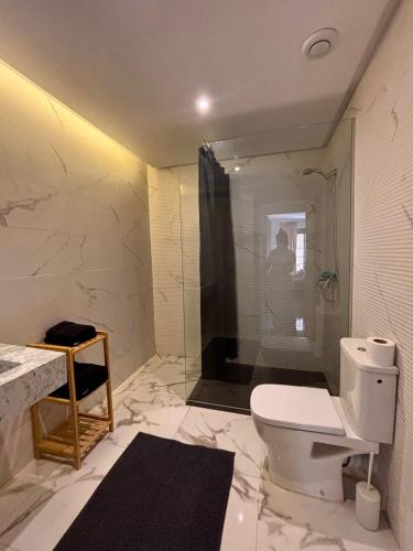 a white bathroom with a toilet and a shower at Nice apartment in Marrakesh in Marrakesh