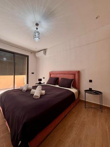a bedroom with a large bed with a red headboard at Nice apartment in Marrakesh in Marrakesh