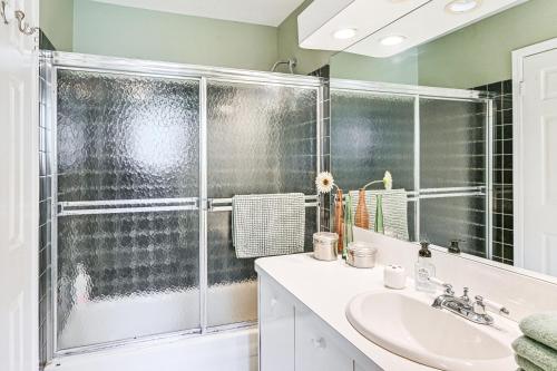 a bathroom with a shower and a sink at Tranquil and Pet-Friendly Estate on Long Island! in Hauppauge