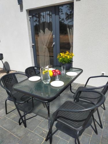 a black table and chairs on a patio at Sielsko Anielsko -Domki Swornegacie in Swornegacie 