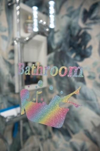 a colorful glass object with the word bathroom at ApArt Gallery Apartment 2, Stylish 3- Bed , Free Parking ,Sleeps 6 in Bedford
