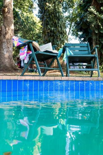 a table and a chair next to a swimming pool at Valhalla on Knelsby in Hillcrest