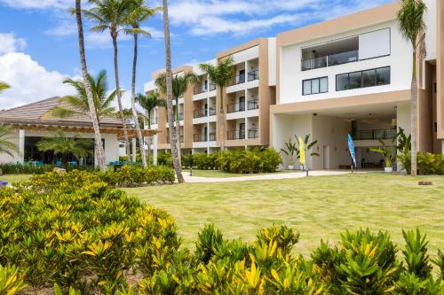 an exterior view of a building with palm trees at Viva Miches by Wyndham, a Trademark All Inclusive Resort in Miches