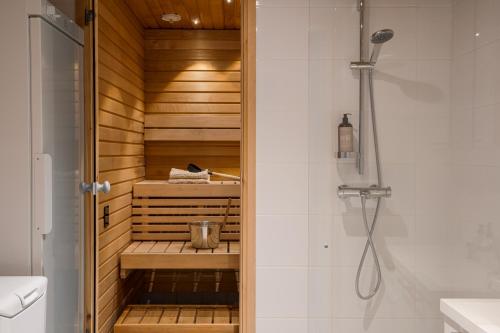 ein Badezimmer mit ebenerdiger Dusche neben einer Toilette in der Unterkunft Auroralevi Sointuilevi B63, Central, Sauna, Ski nearby in Levi