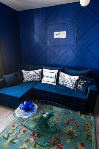 a blue living room with a couch and a table at ApArt Gallery Apartment 2, Stylish 3- Bed , Free Parking ,Sleeps 6 in Bedford