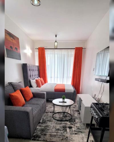 a living room with a couch and a bed at Tusmo homes in Ongata Rongai 