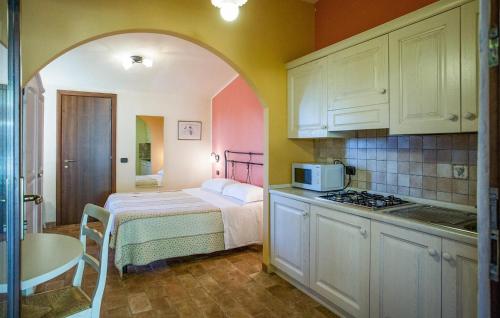 a small kitchen with a bed and a microwave at Amazing Home In San Giovanni in Montefiore dellʼAso