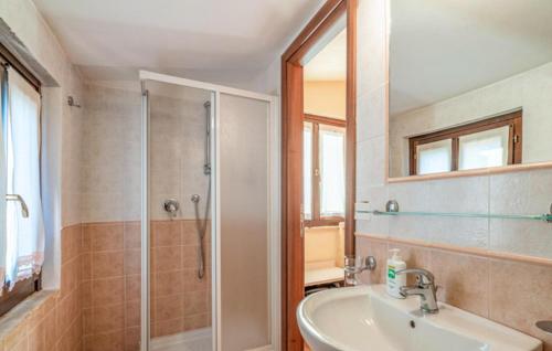 a bathroom with a shower and a sink and a tub at Amazing Home In San Giovanni in Montefiore dellʼAso