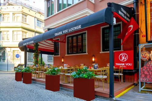 a restaurant with tables and chairs on a street at Thank You Hotel Sultanahmet in Istanbul