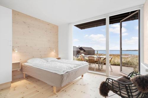 a bedroom with a bed and a view of the ocean at 7716-Hvide-Sande-Slusen-16 in Hvide Sande