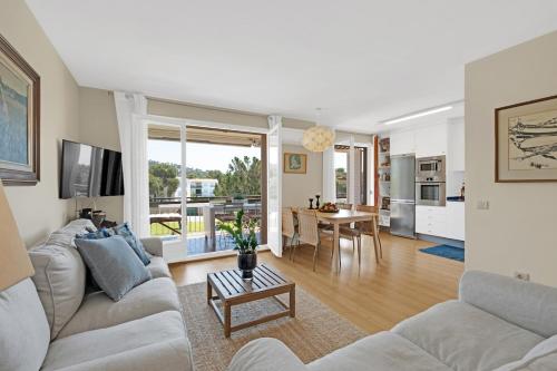 a living room with a couch and a table at Apartment in Calella de Palafrugell with a pool and parking in Calella de Palafrugell