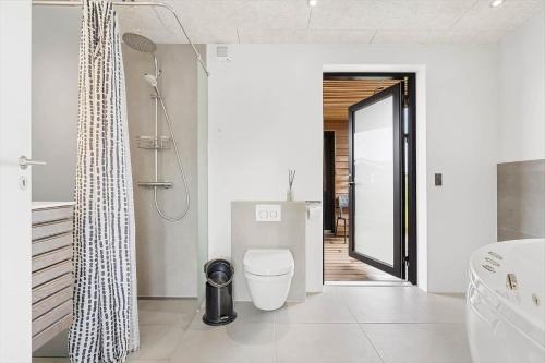 a bathroom with a toilet and a shower at 4426-Hvide-sande-Granvej-4 in Hvide Sande