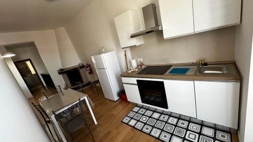 a small kitchen with a sink and a refrigerator at Casa Panoramica in Calabria a circa 5 min dal mare in Villapiana
