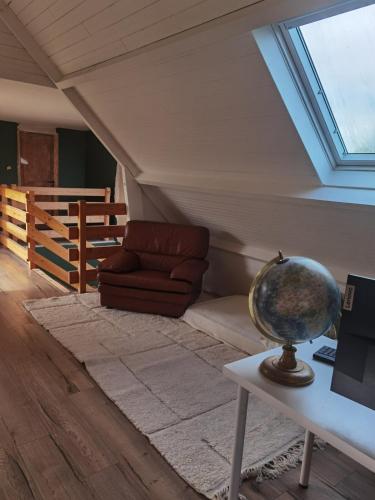 a room with a couch and a globe on a table at Charming house in Finistère in Coray