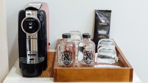 a coffee maker and bottles on a wooden box at voco Royalty Puebla Downtown by IHG in Puebla