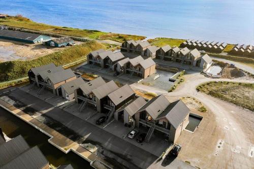 an aerial view of a row of houses next to the ocean at 9928-Hvide-Sande-Langsand-86 in Hvide Sande