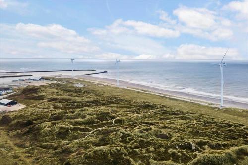 an aerial view of a beach with wind turbines at 9928-Hvide-Sande-Langsand-86 in Hvide Sande