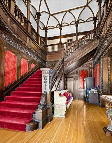 a staircase in a mansion with a red carpet at Historic Cotton Mansion by Heirloom Boutique Collection in Duluth