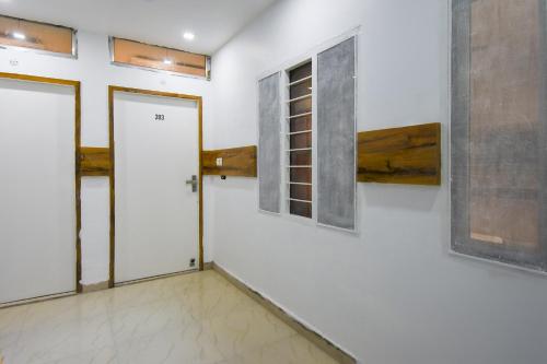 a room with a door and paintings on the wall at Super Hotel o Shivaay Phase 1 Mohali Bus Terminal in Sohāna