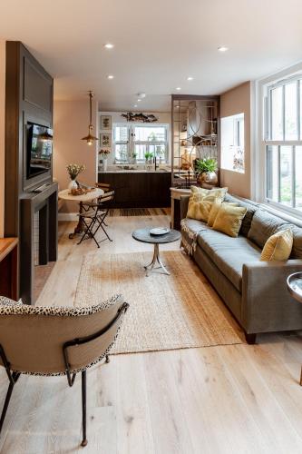 a living room with a couch and a table at Green Maison Westfield in London