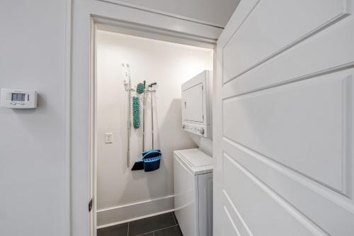 a bathroom with a sink and a washer and dryer at Quiet Downtown Loft in the Heart of Macon in Macon