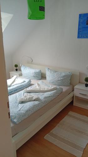 a bed with two pillows on it in a room at Kleine Möwe in Wilhelmshaven