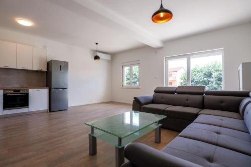 a living room with a couch and a table at Apartman Beljo in Neum