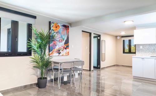a kitchen and dining room with a table and chairs at Fully Renovated Beachfront Family Building 2 6 Beds 4 Baths Ocean Views & Terrace in Dorado