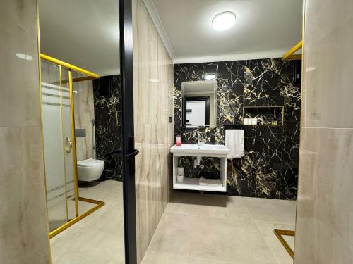 a bathroom with a sink and a toilet at Çakır Residence in Trabzon