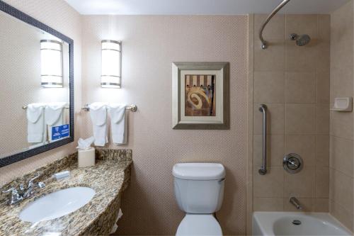 a bathroom with a toilet and a sink and a shower at Hilton Garden Inn Billings in Billings