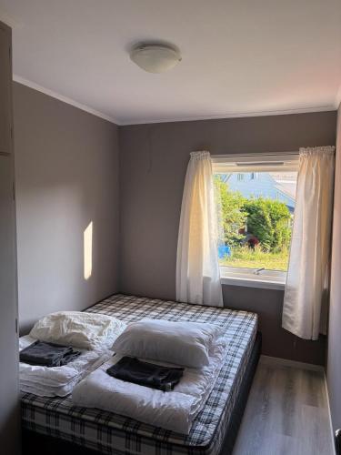 a bedroom with a bed and a window at House in Nordfjord, with 4 bedrooms in Nordfjordeid