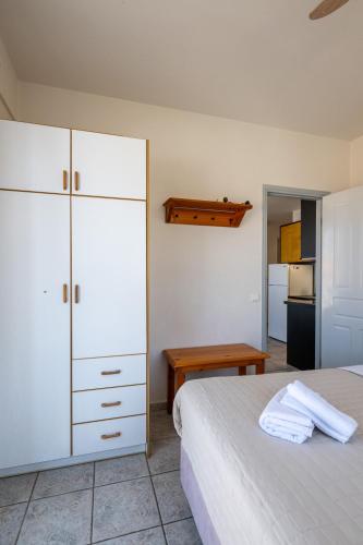 a bedroom with a bed and a white cabinet at Mythos Suites-Apollo apartment in Methoni