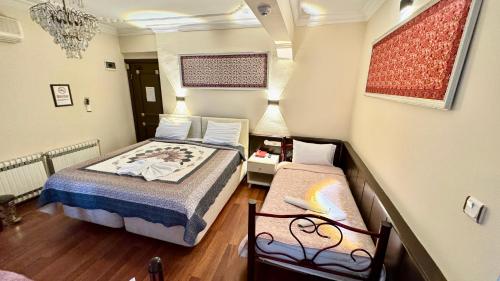 a small room with a bed and a chair in it at EPHESUS CENTRUM in Selcuk
