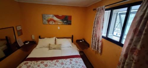 a bedroom with a bed and a window at Hotel Fish in Concepción