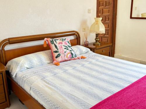 a bed with a pillow on top of it at Ideal pool chalet WBR in La Mata