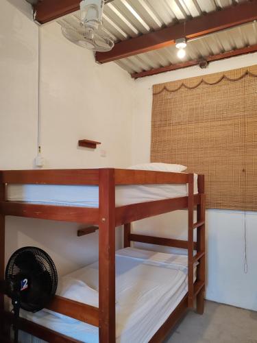 a group of bunk beds in a room at Mochileros de Nicaragua in Moyogalpa