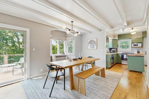a kitchen and dining room with a wooden table and chairs at Balsam House in Baraboo