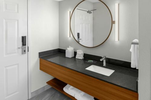 a bathroom with a sink and a mirror at Fairfield Inn & Suites by Marriott San Francisco San Carlos in San Carlos