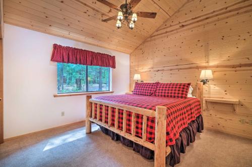 a bedroom with a bed in a log cabin at Game Room and Deck Pet-Friendly Camp Connell Cabin in Camp Connell