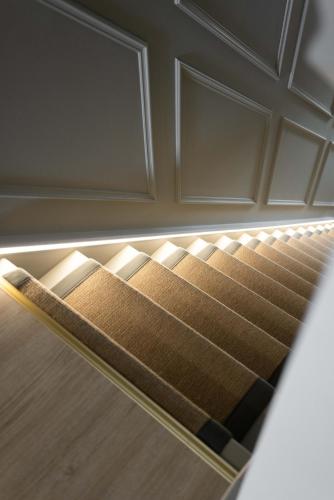 a set of stairs in a room with a door at Large house in centre of Portrush with free parking x 2 cars in Portrush