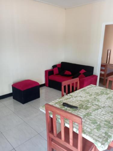 a living room with a couch and a table and chairs at Shalom appartement in Paramaribo