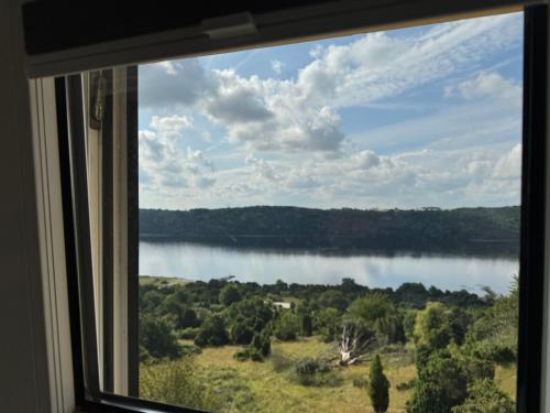 a view of a lake from a window at Bramslev Bakker Naturhotel in Hobro