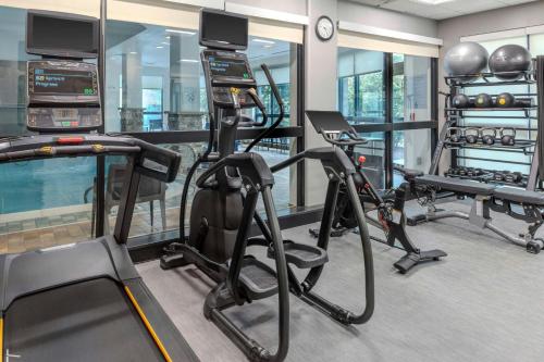 a gym with treadmills and exercise equipment in a room at Courtyard Pittsburgh Greensburg in Greensburg