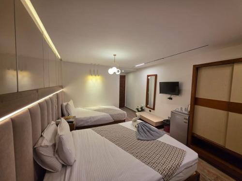Ένα ή περισσότερα κρεβάτια σε δωμάτιο στο Aura Garden City Hotel