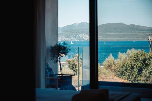 a window with a view of a body of water at Eveline Suite - seaview & short walk to the beach in Nikiana