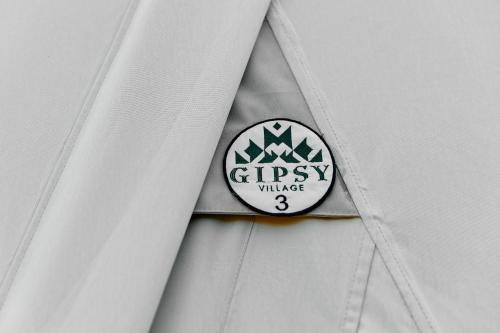 a white shirt with a sly village badge on it at Gipsy Village Park Hotel in Asuretʼi