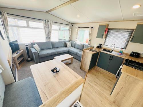 a living room with a couch and a table at 2 Bedroom Caravan FF17, Fairway, Sandown, Isle of Wight in Isle of Wight