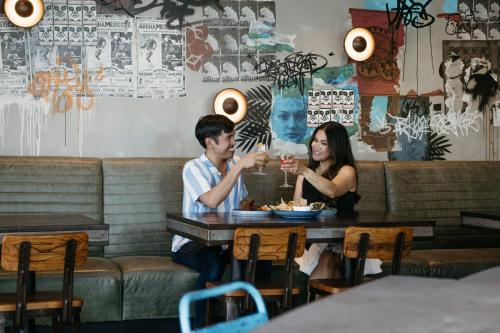 a man and a woman sitting at a table in a restaurant at San Jose Marriott in San Jose