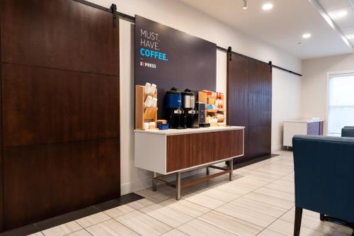 a waiting room with a coffee shop with a counter at Holiday Inn Express & Suites - Edmonton SW – Windermere by IHG in Edmonton